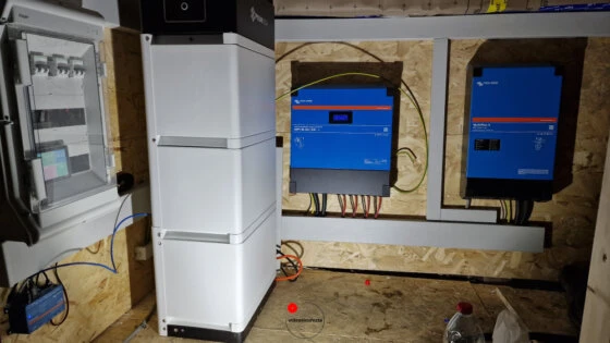 Batteria di accumulo e inverter Victron installati su pannello in legno per gestione energia da impianto solare